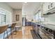 Updated kitchen features stainless steel appliances, stylish white and purple cabinets, and breakfast bar at 1310 Seneca Pl, Charlotte, NC 28209