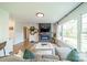 Bright, airy living room featuring a modern fireplace, wall decor, and ample natural light at 1310 Seneca Pl, Charlotte, NC 28209