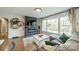 Comfortable living room with modern fireplace and shelving, bathed in natural light from a large window at 1310 Seneca Pl, Charlotte, NC 28209
