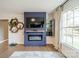 Cozy living room features a modern fireplace with TV, built-in shelving, and ample natural light at 1310 Seneca Pl, Charlotte, NC 28209