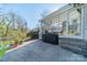Back patio with grill and access to the screened in porch at 1310 Seneca Pl, Charlotte, NC 28209