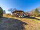 Home exterior featuring a covered wooden porch, landscape beds, and a well-maintained lawn area at 137 Beaverbrook Rd, Statesville, NC 28677