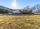Home exterior featuring a wooden deck and a well-maintained lawn area at 137 Beaverbrook Rd, Statesville, NC 28677
