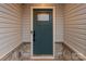 Close up of a teal front door with stone details at 143 Commerce Blvd, Lancaster, SC 29720
