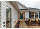 Welcoming front entrance with a teal-colored door and complementary landscaping at 143 Commerce Blvd, Lancaster, SC 29720