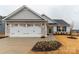 Charming single Gathering home with stone accents, two-car garage, and nicely landscaped yard at 143 Commerce Blvd, Lancaster, SC 29720