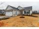 Beautiful single Gathering home with lush lawn, stone accents, and attached two-car garage at 143 Commerce Blvd, Lancaster, SC 29720