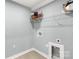 Functional laundry room with wire shelving for storage solutions and space for modern washer/dryer units at 143 Commerce Blvd, Lancaster, SC 29720
