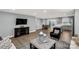 Open-concept living room showcasing hardwood floors and seamless flow to the kitchen and dining area at 143 Commerce Blvd, Lancaster, SC 29720