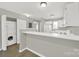 Open kitchen with white appliances, washer and dryer, and counter space at 1642 Eagles Pl # H-103, Rock Hill, SC 29732