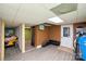 Unfinished basement showcasing a doorway, wood-look floors, and partial furnishings at 17154 Frog Pond Rd, Oakboro, NC 28129