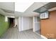 Partially finished basement featuring gray flooring, drywall, drop ceiling, and a utility unit at 17154 Frog Pond Rd, Oakboro, NC 28129