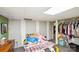 Basement bedroom featuring bare drywall, wood-look floors, and a closet full of clothes at 17154 Frog Pond Rd, Oakboro, NC 28129