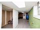 Unfinished basement with a door to the exterior, concrete walls, and a drop ceiling at 17154 Frog Pond Rd, Oakboro, NC 28129