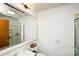 Bright bathroom featuring a sink, toilet, mirror, and a shower with a glass door at 17154 Frog Pond Rd, Oakboro, NC 28129