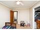 Modest bedroom featuring a doorway to the bath, twin bed, closet and ceiling fan at 17154 Frog Pond Rd, Oakboro, NC 28129