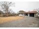 Well-maintained ranch-style home with neutral exterior, gravel driveway, and manicured front yard at 17154 Frog Pond Rd, Oakboro, NC 28129