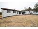 Ranch style house with white brick, black trim, and a large front yard. RV and auto in driveway at 17154 Frog Pond Rd, Oakboro, NC 28129