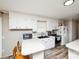 Bright kitchen with white cabinets and a functional layout for cooking and dining at 17154 Frog Pond Rd, Oakboro, NC 28129