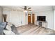 Cozy living room featuring wood floors, a ceiling fan, and a comfortable couch at 17154 Frog Pond Rd, Oakboro, NC 28129