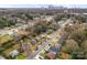 Aerial view of a neighborhood with mature trees and downtown city skyline at 1826 Taylor Ave, Charlotte, NC 28216