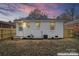 Cozy backyard featuring a newly painted white brick home and enhanced lawn at 1826 Taylor Ave, Charlotte, NC 28216