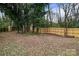 Fenced backyard with mature trees at 1826 Taylor Ave, Charlotte, NC 28216