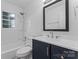 Bright bathroom featuring modern fixtures, a shower-tub combo, and a navy blue vanity at 1826 Taylor Ave, Charlotte, NC 28216