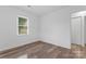 Bright bedroom featuring modern wood-look flooring and a window that provides natural light at 1826 Taylor Ave, Charlotte, NC 28216