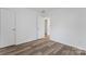 Bright bedroom featuring wood floors, neutral paint, and ample closet space at 1826 Taylor Ave, Charlotte, NC 28216