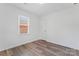 Bedroom featuring vinyl floors, a window view, and a neutral color palette at 1826 Taylor Ave, Charlotte, NC 28216