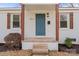 Inviting front entrance with updated landscaping, a blue door, and decorative shutters at 1826 Taylor Ave, Charlotte, NC 28216