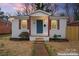 Charming home with a neatly landscaped front yard, featuring updated paint, front door and shutters at 1826 Taylor Ave, Charlotte, NC 28216