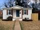 Charming home with a neatly landscaped front yard, featuring updated paint, front door and shutters at 1826 Taylor Ave, Charlotte, NC 28216