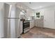 Modern kitchen features stainless steel appliances, granite countertops, and stylish grey cabinetry at 1826 Taylor Ave, Charlotte, NC 28216
