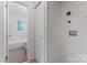 Bright laundry room with modern hookups and neutral tones adjacent to bathroom at 1826 Taylor Ave, Charlotte, NC 28216