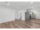 Open living room showcasing wood floors, modern lighting, and neutral paint at 1826 Taylor Ave, Charlotte, NC 28216