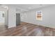 Open living room featuring hardwood floors, modern lighting, and bright windows at 1826 Taylor Ave, Charlotte, NC 28216