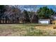 Large backyard with a shed surrounded by mature trees at 1841 Ellick Dr, Newton, NC 28658