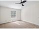 Bright bedroom featuring neutral walls, carpet flooring, and a ceiling fan at 1841 Ellick Dr, Newton, NC 28658