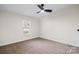 Bright bedroom featuring neutral walls, carpet flooring, and a ceiling fan at 1841 Ellick Dr, Newton, NC 28658