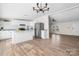 Kitchen featuring white cabinets, granite countertops, stainless appliances and island adjoining the living area at 1841 Ellick Dr, Newton, NC 28658
