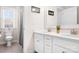 Bright bathroom features double sink vanity with white cabinets and tile flooring at 2024 Linn Cv, Waxhaw, NC 28173