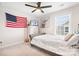 Bedroom boasts a ceiling fan, natural light and an American flag on the wall at 2024 Linn Cv, Waxhaw, NC 28173