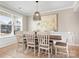 Bright dining room featuring crown molding, large windows, and a stylish light fixture at 2024 Linn Cv, Waxhaw, NC 28173