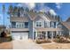 Charming two-story home with a spacious front porch, blue siding, and a two-car garage at 2024 Linn Cv, Waxhaw, NC 28173