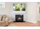 Stylish fireplace with decorative surround, a large TV, and a cozy ambiance in the living area at 2024 Linn Cv, Waxhaw, NC 28173
