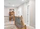 Upstairs hallway showcasing a decorative cabinet and access to multiple rooms at 2024 Linn Cv, Waxhaw, NC 28173
