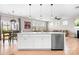 Open-concept kitchen with a large island, stainless steel dishwasher, and seamless flow into the living area at 2024 Linn Cv, Waxhaw, NC 28173