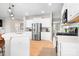 Modern kitchen with white cabinets, stainless steel appliances, a central island, and hardwood floors at 2024 Linn Cv, Waxhaw, NC 28173